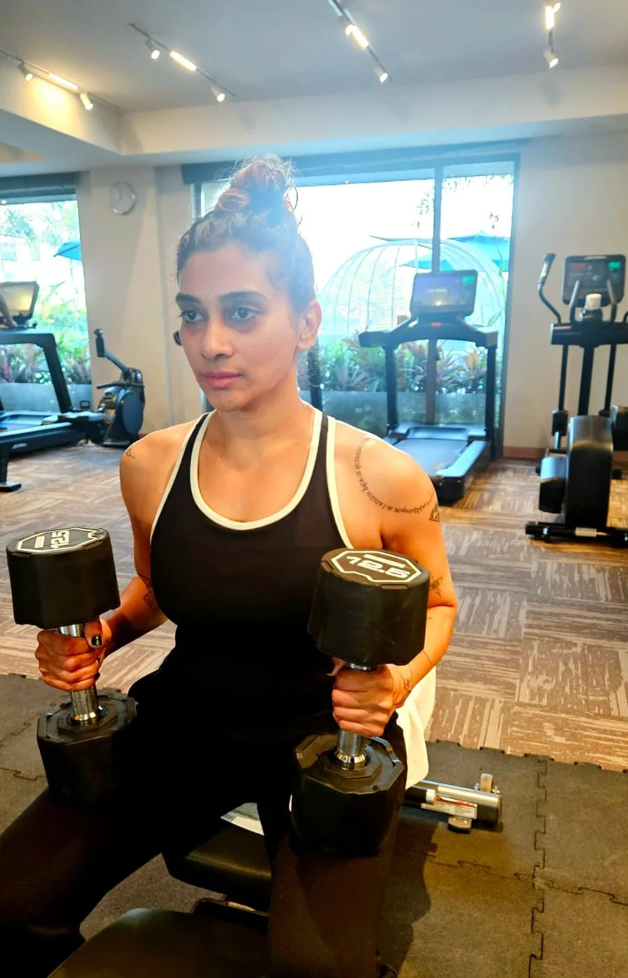 Coach guiding a dumbbell strength drill during a WellSync360 workshop
